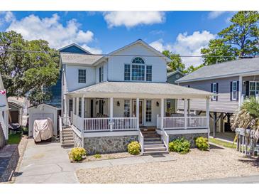 Charming two-story home with a wide porch, stone accents, and mature landscaping offers curb appeal at 6001- P16A S Kings Highway, Myrtle Beach, SC 29575