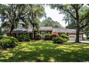 Charming brick home featuring manicured landscaping and a welcoming front entrance at 951 Herriott Farms Dr., Georgetown, SC 29440