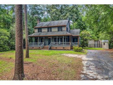 Charming two-story home with a welcoming front porch and beautifully wooded surroundings, inviting relaxation at 1072 Chelsey Circle, Conway, SC 29526