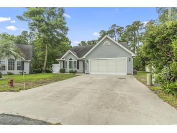 Charming home with a two-car garage and a well-maintained lawn at 1331 Bermuda Ct., Surfside Beach, SC 29575