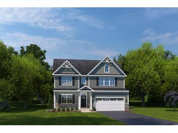 Charming two-story home with a two-car garage, a well-maintained lawn and beautiful landscaping at 1408 Whistling Straits Way, Sunset Beach, NC 28468