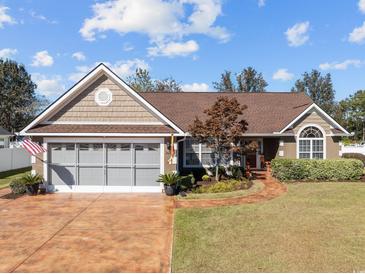 Charming single-story home with a well-manicured lawn, attached garage, and inviting front walkway at 200 Silverbelle Blvd., Longs, SC 29568
