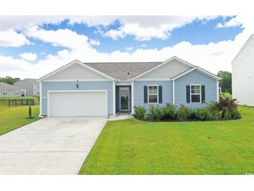 Charming single-story home featuring a two-car garage, manicured lawn, and inviting curb appeal at 2002 Sweetflag Dr., Longs, SC 29568