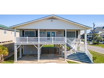 Charming beach house featuring a white picket fence and elevated porch, perfect for enjoying ocean breezes at 3307 Nixon St., North Myrtle Beach, SC 29582