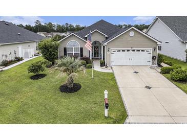 Charming one-story home with well-manicured lawn, palm tree, and an American flag at 388 Sea Turtle Dr., Myrtle Beach, SC 29588