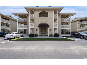 Beautiful tan condominium with multiple balconies and covered entrance at 4290 Pinehurst Circle # B3, Little River, SC 29566