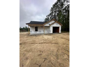 New construction exterior with Tyvek wrap, black roof and attached garage, ready for customization at 5713 S Highway 41, Marion, SC 29571