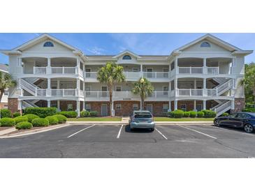 Inviting condo exterior with multiple balconies, palm trees, and convenient parking at 6015 Catalina Dr. # 932, North Myrtle Beach, SC 29582