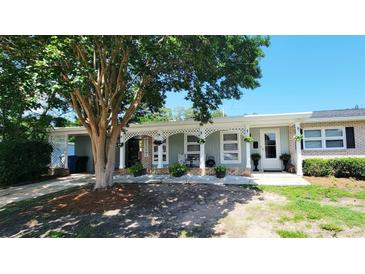 Charming one-story home with a welcoming front porch and a beautiful mature tree in the front yard at 610 Hibiscus Ave. # 610, Myrtle Beach, SC 29572