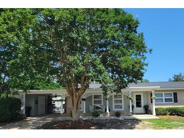 Charming home featuring light-colored siding, brick accents, and a welcoming, lattice-adorned porch at 610 Hibiscus Ave. # 610, Myrtle Beach, SC 29577