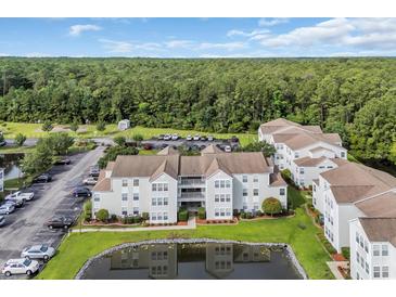 An aerial view of the condo community with a pond, landscaping, and ample parking at 8658 Southbridge Dr. # L, Myrtle Beach, SC 29575