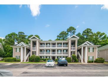 Low angle view of a condominium with beautiful trees and landscaping at 1125 Blue Stem Dr. # 29F, Pawleys Island, SC 29585