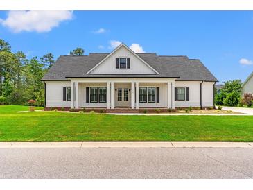 Charming single-Gathering home with a covered front porch, manicured lawn, and traditional architectural style at 116 Sago Palm Dr., Myrtle Beach, SC 29579