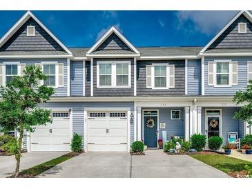 Charming townhome with gray siding, white trim, and a well-manicured lawn at 153 Goldenrod Circle # 7D, Little River, SC 29566