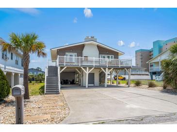 Inviting exterior of home featuring a charming front deck, convenient parking, and beachside vibe at 204 55Th Ave. N, North Myrtle Beach, SC 29582