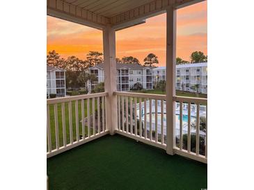 Enjoy sunset views of the community pool from this cozy condo balcony at 2498 Coastline Ct. # 301, Murrells Inlet, SC 29576