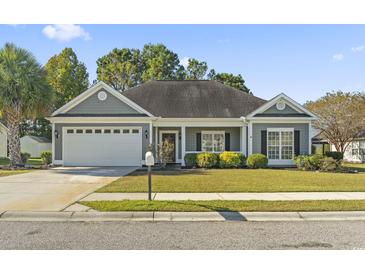 Charming single-story home with a two-car garage and well-maintained landscaping at 2715 Wood Creek Ln., Conway, SC 29527