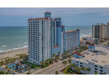 View of a multi-story resort with a pool, balconies, and proximity to the ocean and beach at 3000 N Ocean Blvd. # 230, Myrtle Beach, SC 29577