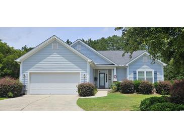 Charming single-story home with a two-car garage, manicured lawn, and inviting curb appeal at 309 Outboard Dr., Murrells Inlet, SC 29576