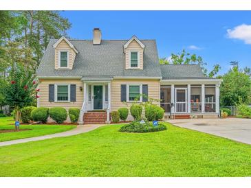 Charming home with a lush, green lawn, manicured shrubs, and inviting landscaping, plus a driveway and screened porch at 401 Harmon Park Blvd., Marion, SC 29571