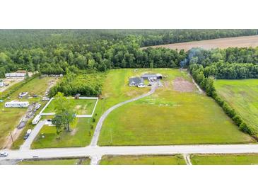Expansive property featuring a well-maintained home, large yard, outbuildings, and surrounding natural landscape at 4486 Bethel Rd., Aynor, SC 29511