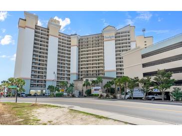 Hotel exterior with multiple levels, balconies, signage, and lush greenery in a well-maintained landscape at 4800 S Ocean Blvd. # 920, North Myrtle Beach, SC 29582