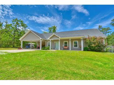 Charming single-story home with a large front yard, covered parking, and a welcoming front porch at 4867 Wolf Trail, Conway, SC 29527