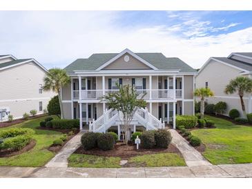 Inviting condo with a lush landscape and white staircases leading to the covered porches at 964 Great Egret Circle Sw # B, Sunset Beach, NC 28468