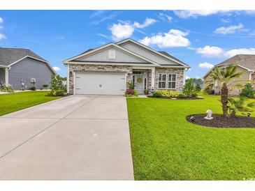 Charming single-story home featuring stone accents, manicured landscaping, and an attached two-car garage at 136 Crabapple Dr., Longs, SC 29568