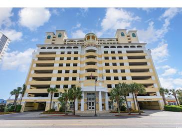 Elegant condo building featuring a parking garage and palm trees near the entrance at 2000 N Ocean Blvd. # 1810, Myrtle Beach, SC 29577