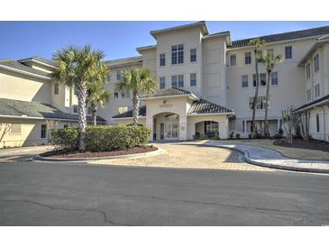 Elegant building exterior with lush landscaping and a welcoming entrance with interlocking brick drive at 2180 Waterview Dr. # 738, North Myrtle Beach, SC 29582
