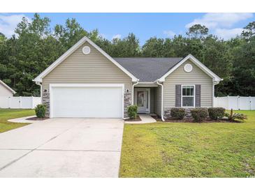 Charming single-story home featuring stone accents, a manicured lawn, and an attached two-car garage at 276 Avery Dr., Myrtle Beach, SC 29588