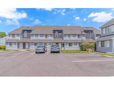 Charming townhouse with blue siding, a gray roof, and convenient parking in front at 3700 Golf Colony Lane # 25-D, Little River, SC 29566