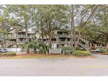 Well-maintained condos feature mature trees, lush landscaping and multiple levels with private balconies at 404 72Nd Ave. N # 301, Myrtle Beach, SC 29572