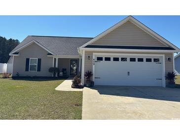 Charming single-story home features a well-manicured lawn, two-car garage, and covered front entry at 429 Oakham Dr., Conway, SC 29526