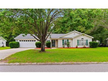 Charming single-story home with well-manicured lawn, mature tree and attractive landscaping at 556 Crusade Circle, Conway, SC 29526