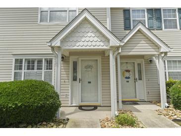 Charming townhouse entrance with covered porch and decorative welcome sign at 611 2Nd Ave. S # 18-C, North Myrtle Beach, SC 29582