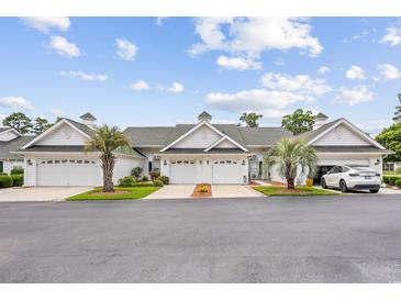 Charming townhomes with attached garages, lush landscaping, and pristine white siding at 612 Intracoastal Way Dr. # 103, Myrtle Beach, SC 29579