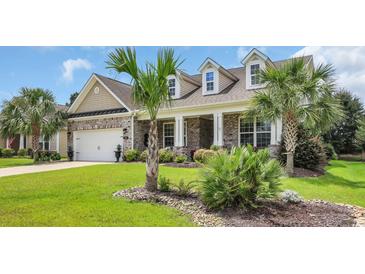Charming brick home featuring a well-manicured lawn and palm trees at 698 Lafayette Park Dr., Little River, SC 29566