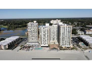A stunning aerial view of a beachfront condo community with pools and beautiful landscaping at 9550 Shore Dr. # 1733, Myrtle Beach, SC 29579