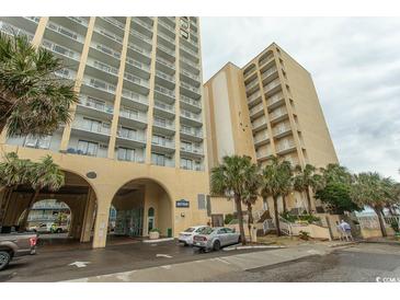 View of condo building featuring multiple stories and balconies, with palm trees in front at 1207 S Ocean Blvd. # 20403, Myrtle Beach, SC 29577