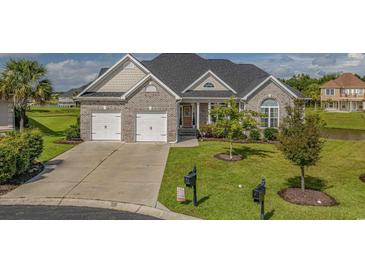 Charming brick home with a well-manicured lawn and two-car garage at 1323 Ashboro Ct., Myrtle Beach, SC 29579