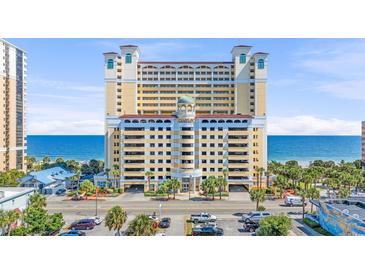 Stunning view of the yellow condo building with palm trees and access to a beautiful beach at 2000 N Ocean Blvd. # 1209, Myrtle Beach, SC 29577