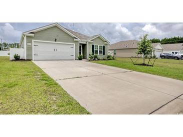 Charming one-story home featuring an attached garage, well-maintained lawn, and a spacious concrete driveway at 211 Seasons Trace Loop, Longs, SC 29568