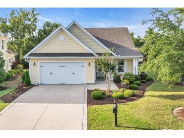 Charming single-story home featuring a two-car garage, well-maintained lawn, and tasteful landscaping at 2336 Tidewatch Way, North Myrtle Beach, SC 29582