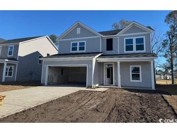 Charming two-story home with gray siding, an open garage, and an inviting front entrance at 3012 Palma Way, Myrtle Beach, SC 29579