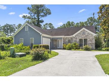 Charming single-story home with a well-manicured lawn, long driveway and a mix of brick and siding accents at 4197 Friendfield Trace, Little River, SC 29566