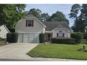 Charming two-story home with a well-manicured lawn, two car garage, and inviting curb appeal at 4570 Fringetree Dr., Murrells Inlet, SC 29576