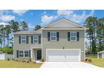 Charming two-story home featuring a two-car garage, gray siding, and green shutters against a backdrop of trees and a blue sky at 743 Chazen Way, Longs, SC 29568