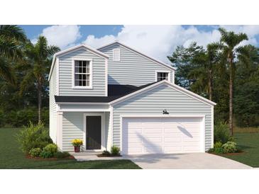 Charming two-story home featuring a two-car garage, and a manicured lawn with vibrant green grass at Lot 149 Tibetan St., Conway, SC 29526